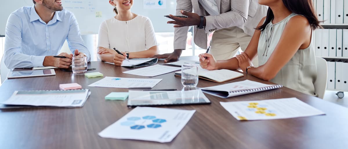 A team reviewing strategy around a meeting table